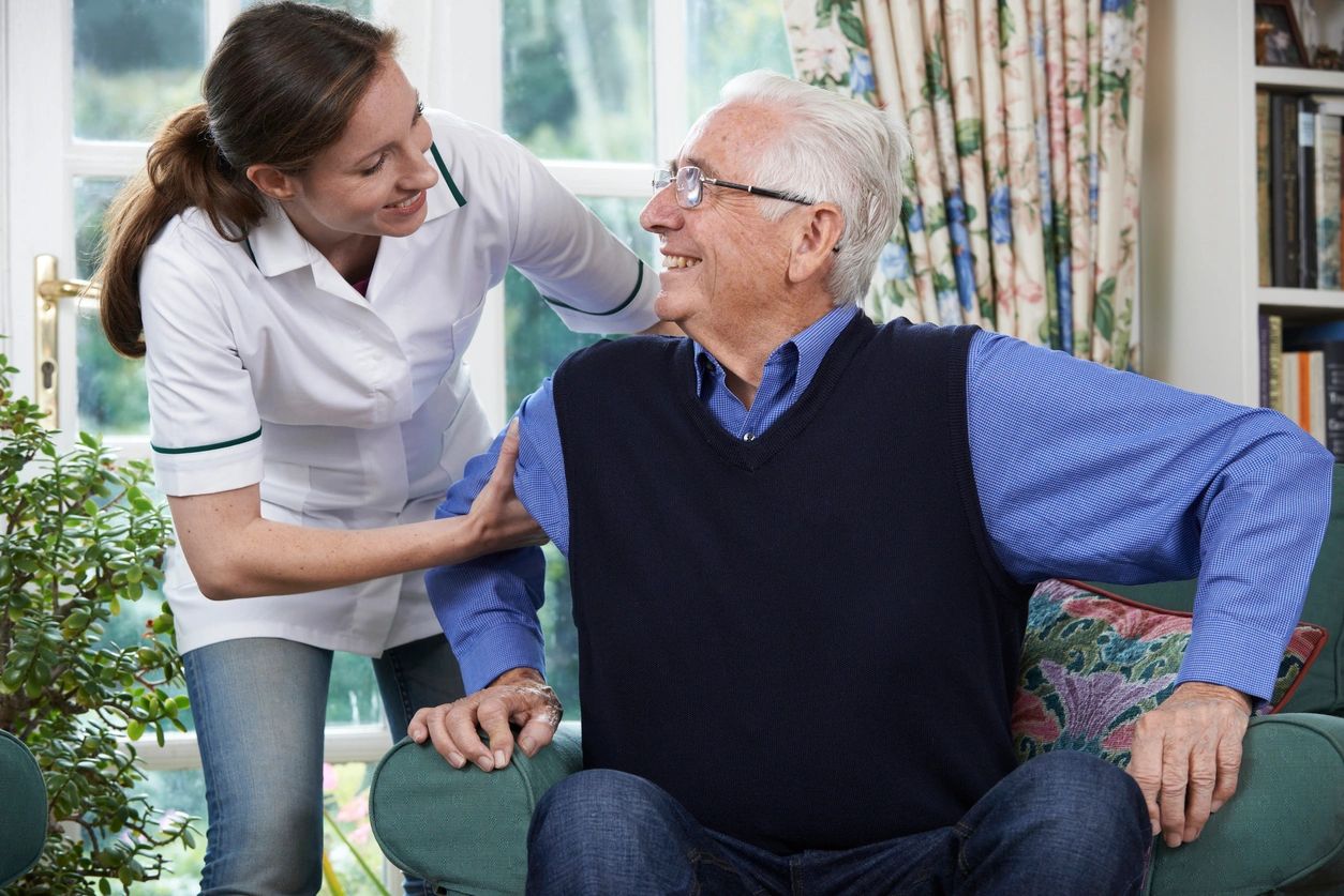 Care Worker Helping old man with Smile